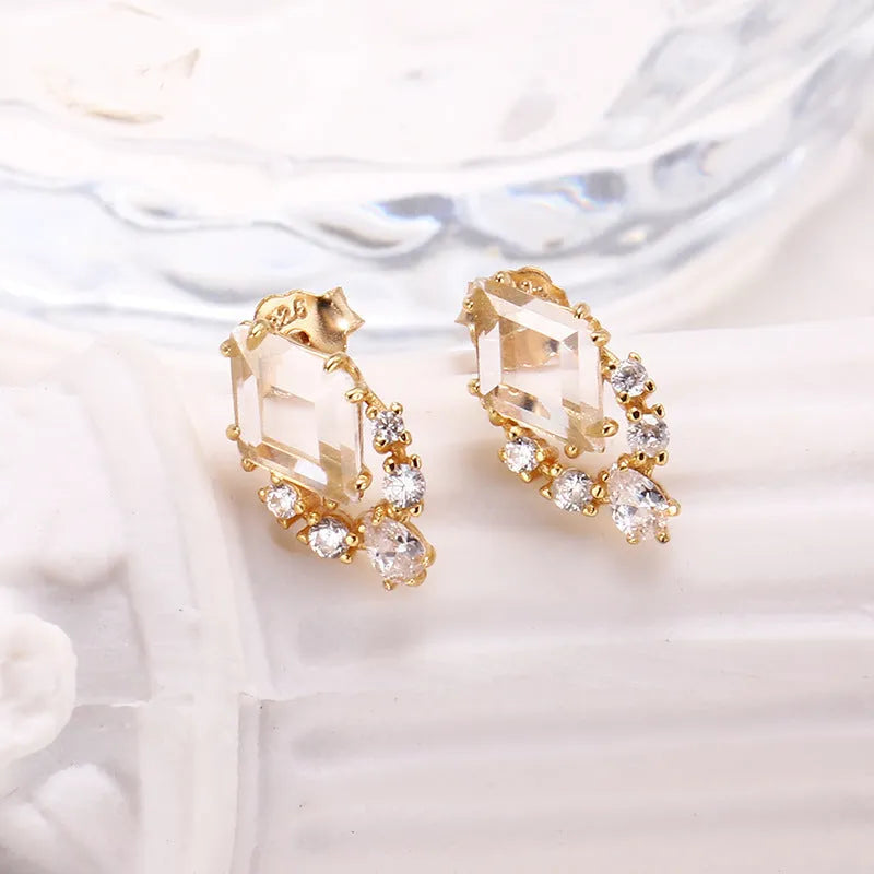 Geometric 925 silver ear studs with natural white crystal accents on simple background
