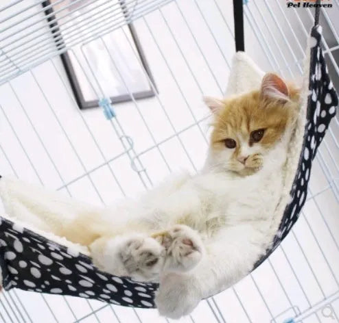 Double-sided lambskin cat hammock nest hanging in a cat cage with beige cat print pattern