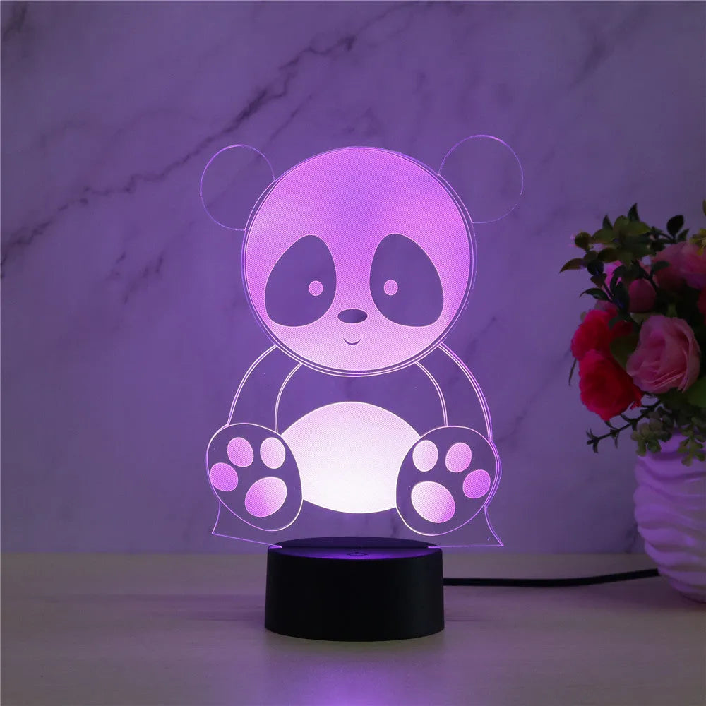 Panda-shaped acrylic night light with remote control on a table, showing multi-coloured LED illumination.