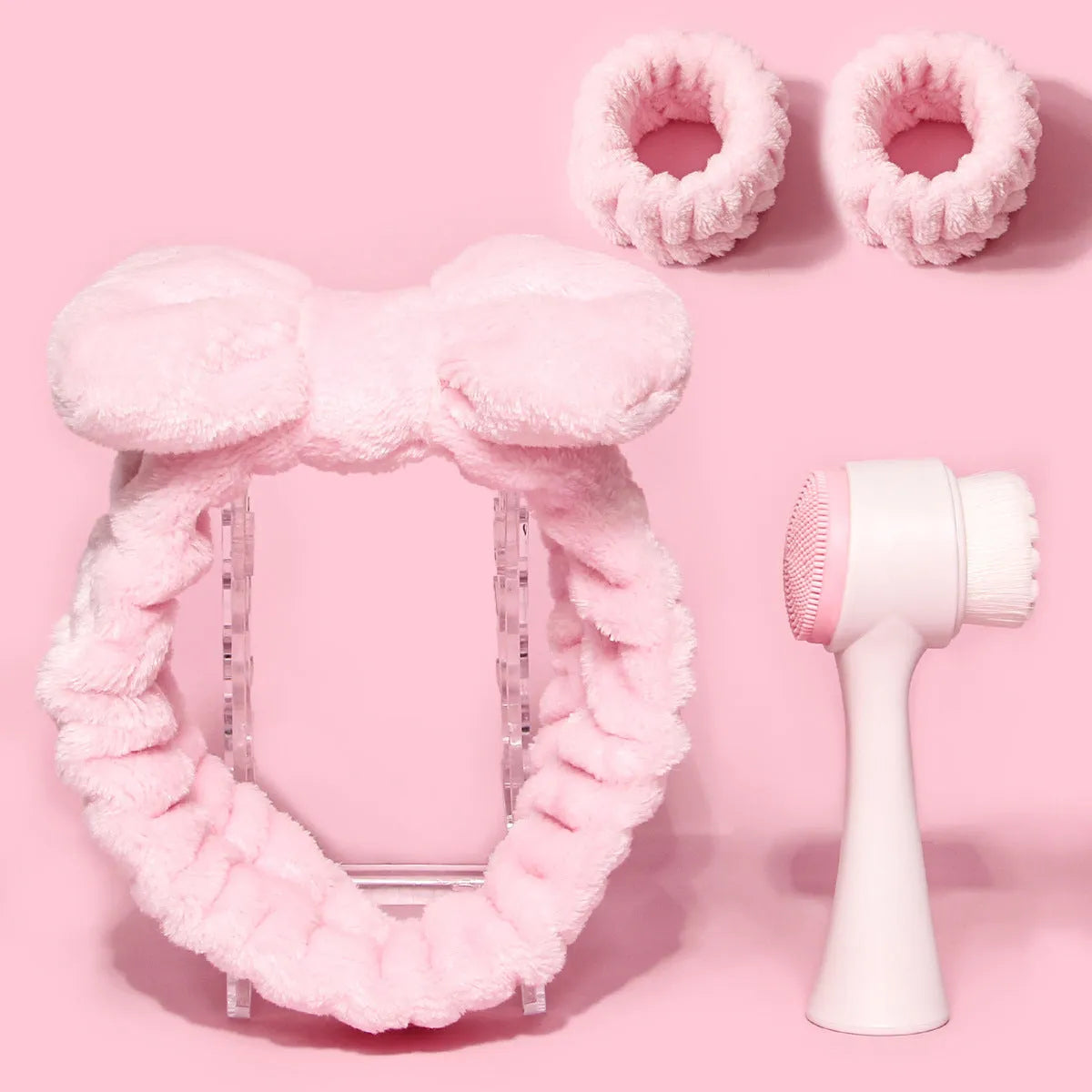 Three-piece facial skincare set showing a nylon brush and a coral fleece hair band in purple.
