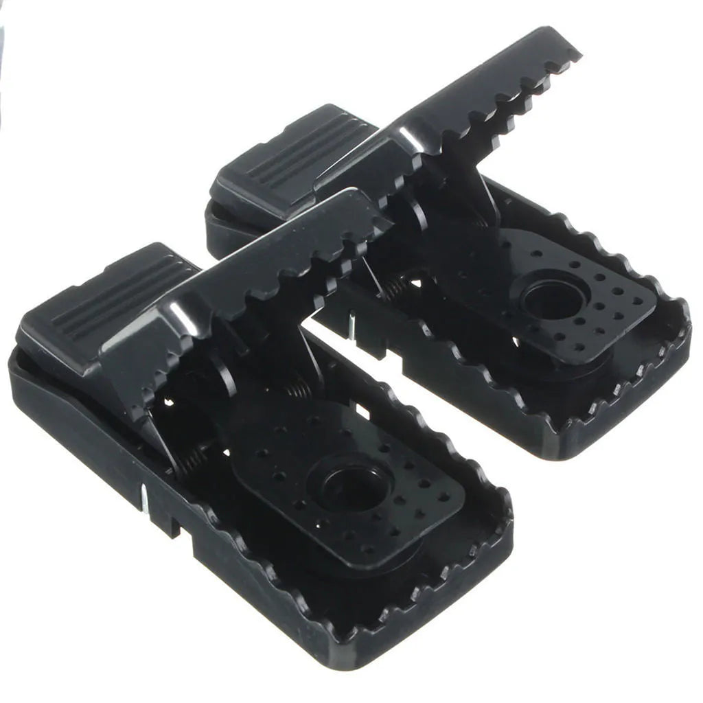 Six black plastic snapping mousetraps showing compact size and smooth surface