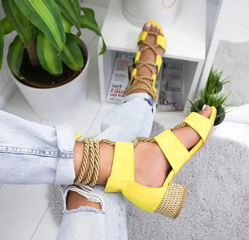 Women's beige suede sandals with thick heel, fish mouth toe, and front ankle strap.