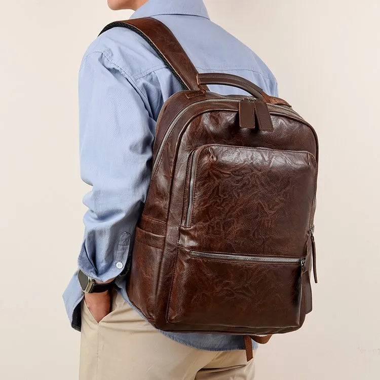 American vintage waterproof backpack 20-35L with PU lining and curved shoulder straps in black, brown, dark brown, or yellowish brown.