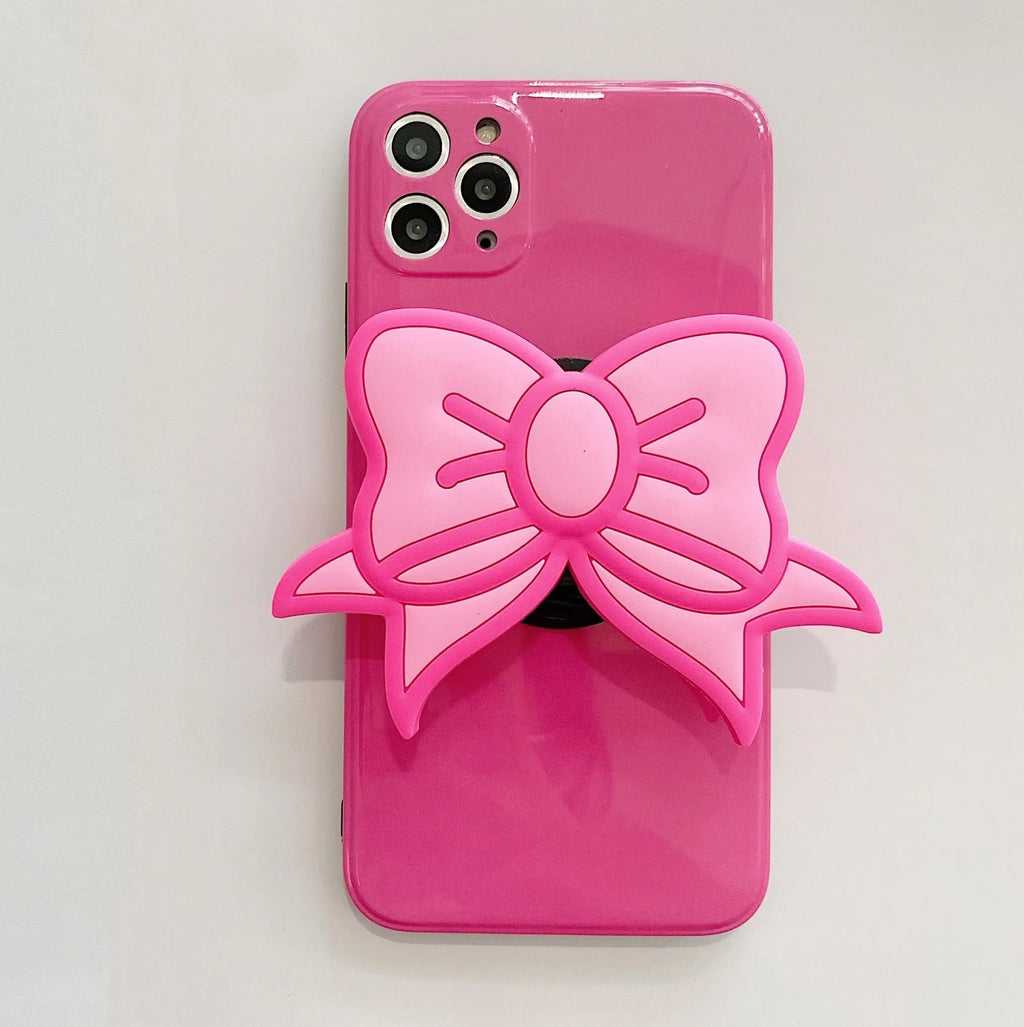 Rose red iPhone case with a pink bow design and a fold-out kickstand on the back.