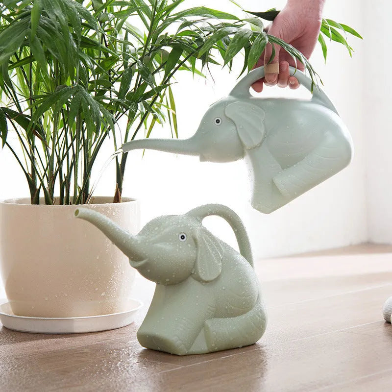 Pink baby elephant shaped plastic watering can with a long spout and bottle-style handle.