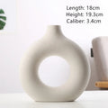 A simple modern frosted porcelain biscuit vase in a neutral colour, for flower arranging.