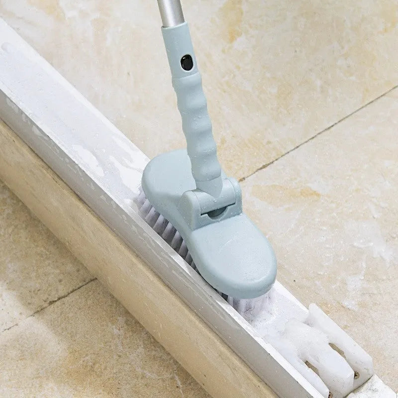 Blue long handle floor brush with telescopic aluminium rod and detachable nylon bristle head on tiled floor
