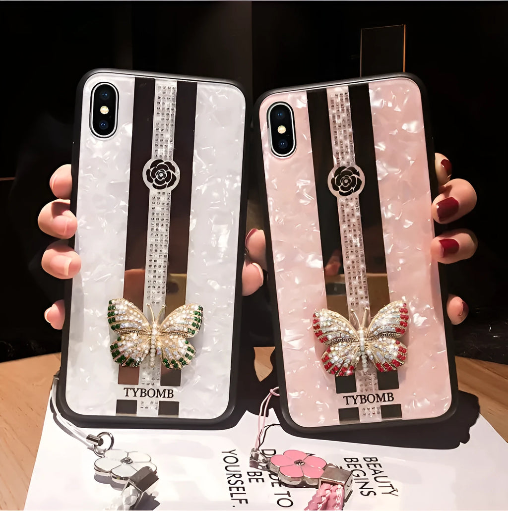 Pearl-coloured acrylic iPhone case with diamond patterns, butterfly design, and a central mirror panel.