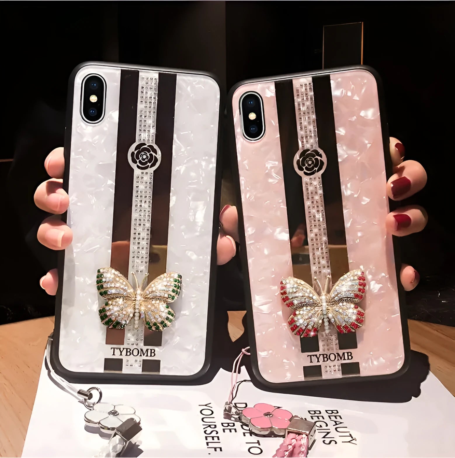 Pearl-coloured acrylic iPhone case with diamond patterns, butterfly design, and a central mirror panel.