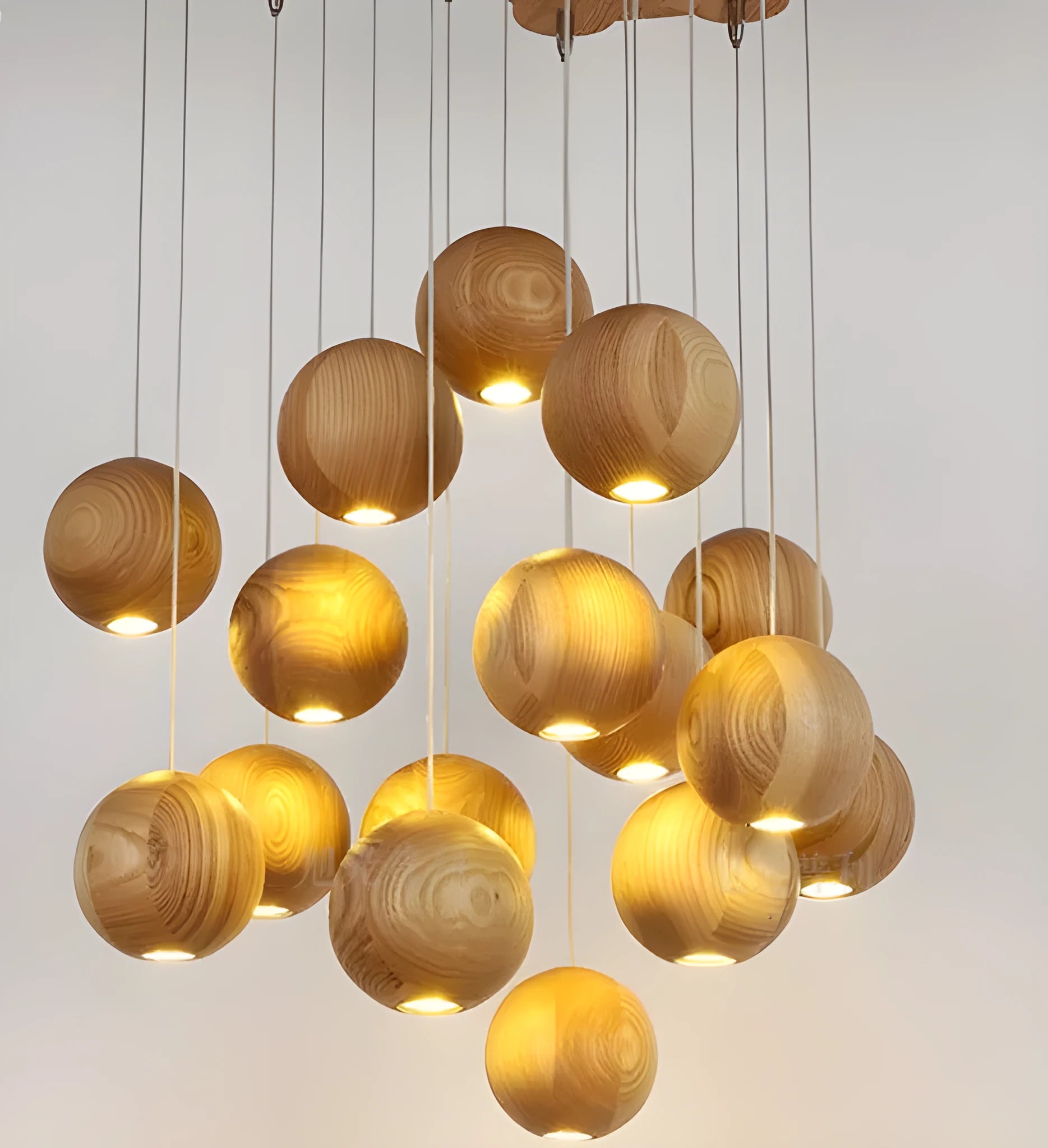 Nordic style wooden ball chandelier with solid wood construction hanging from a ceiling on an adjustable cord.