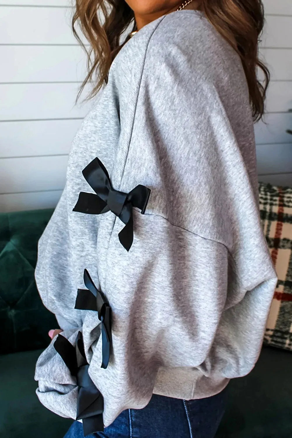 Women's light gray long sleeve ribbon slit letter shirt pullover front view on model