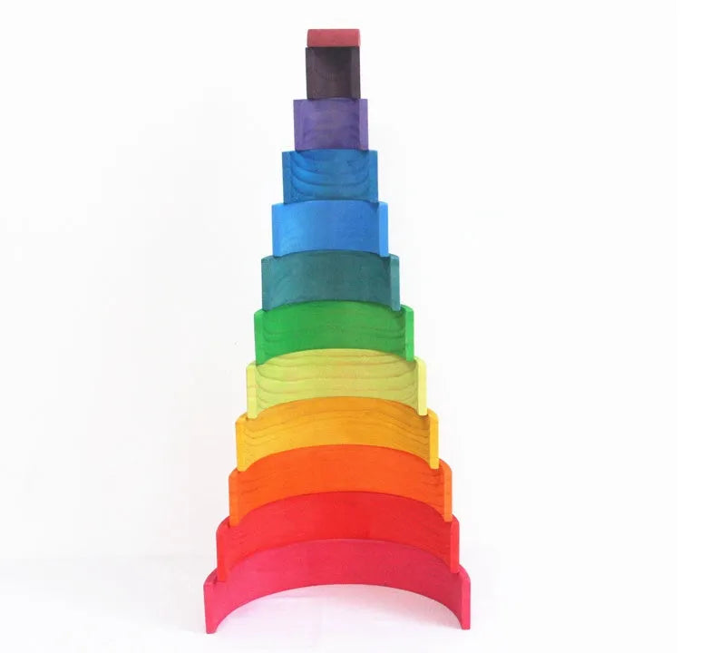 12-piece wooden arch bridge rainbow building blocks made from New Zealand pine with light lacquer finish on a flat surface