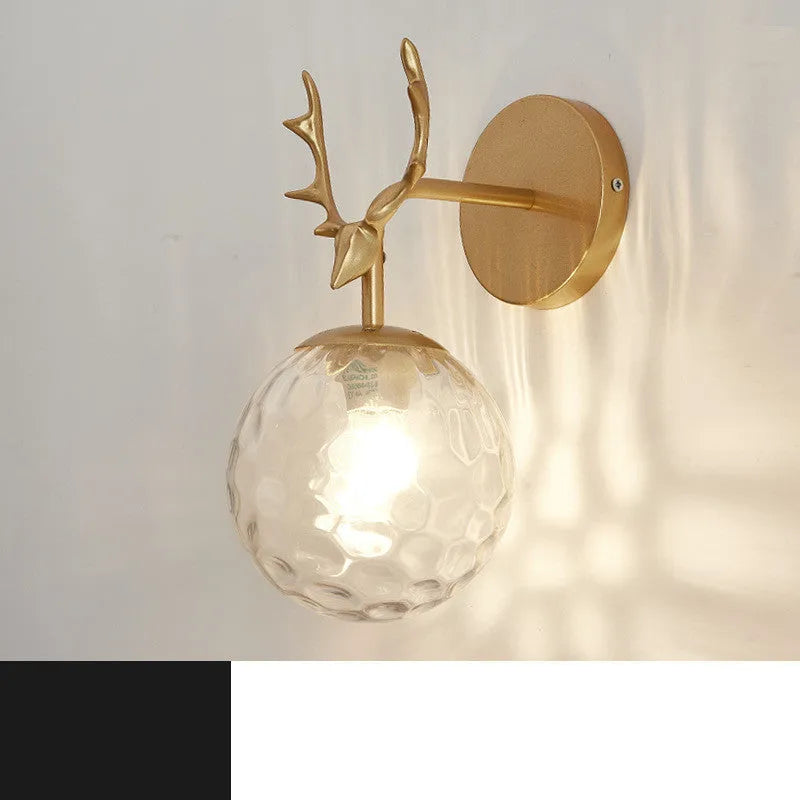 Modern round glass wall sconce with translucent shade mounted on a plain wall, demonstrating ambient light diffusion.