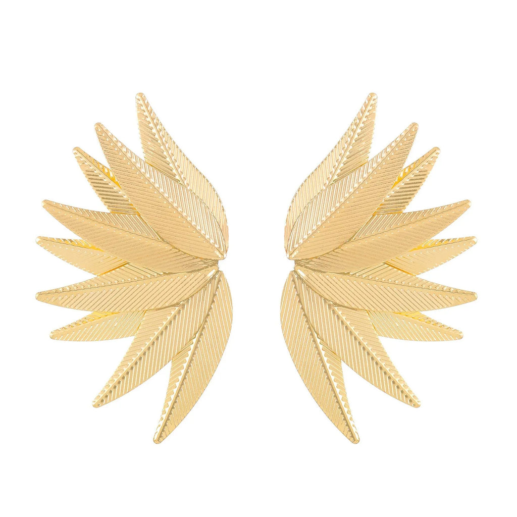 Gold and white alloy leaf-shaped patch earrings on a plain background