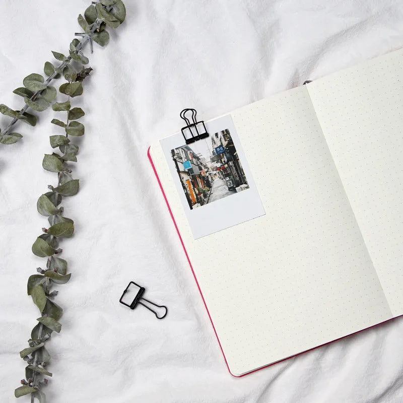 Blue A5 dotted notebook with soft imitation leather cover open to show dot grid pages