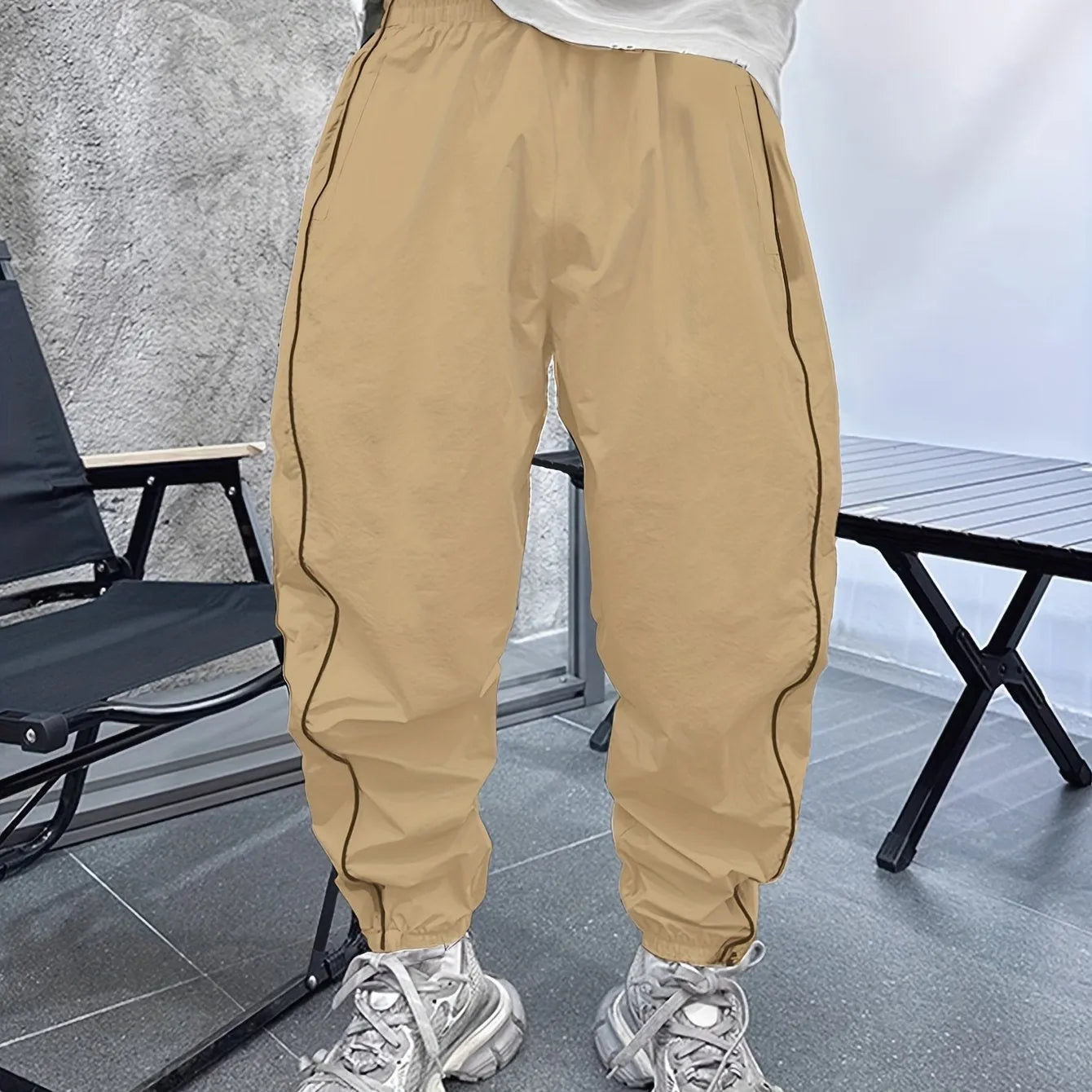 Man wearing loose-fit, cropped bamboo fibre casual trousers in Army Green.