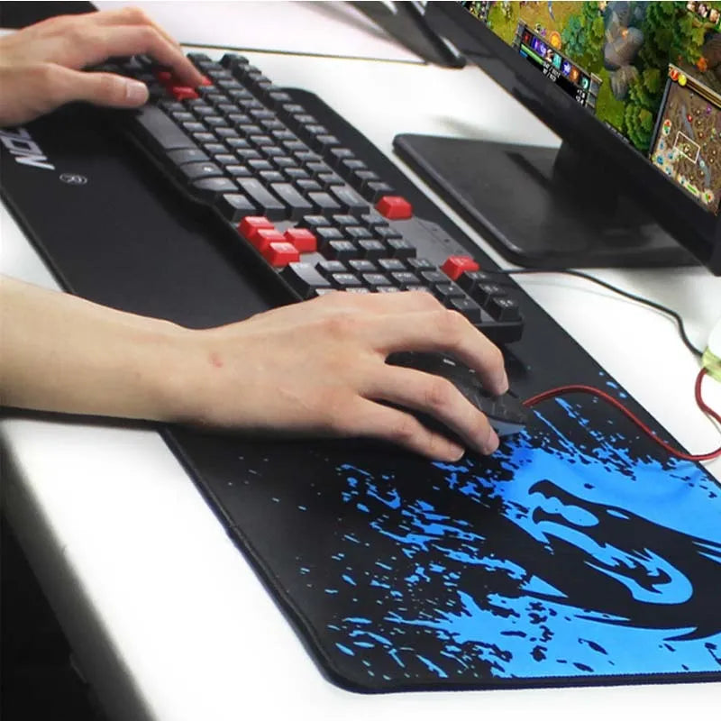 Mouse pad with textured surface and reinforced stitching edges on a desk