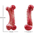 Red natural rubber chew toy for aggressive chewing dogs on wooden floor