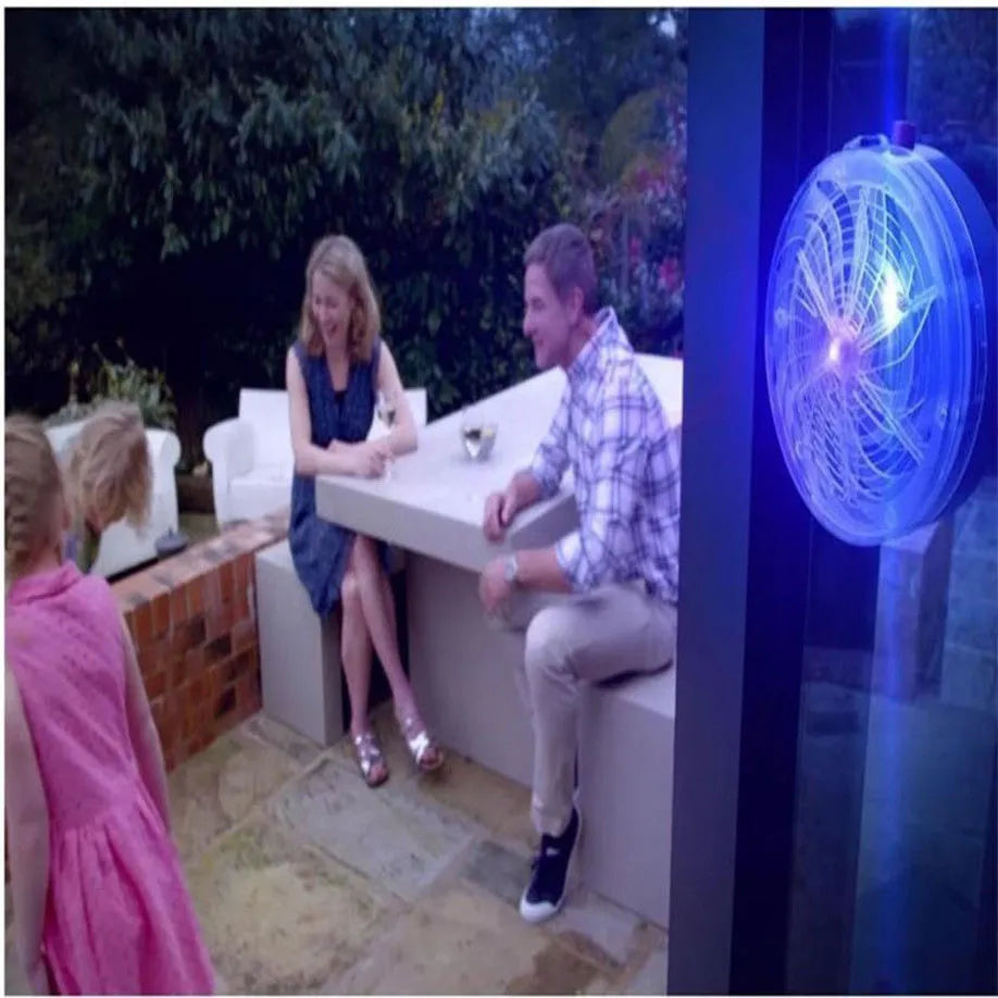 Solar bug zapper for mosquitoes and insects, white and black design on a table in a garden