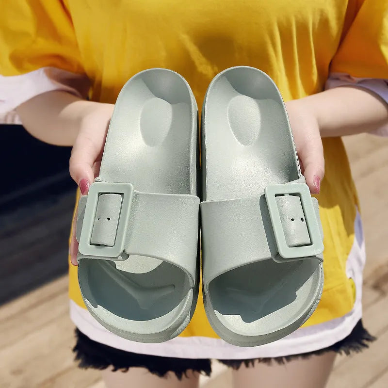 Women's grey blue EVA flip-flop sandals with a buckle strap on a white background.