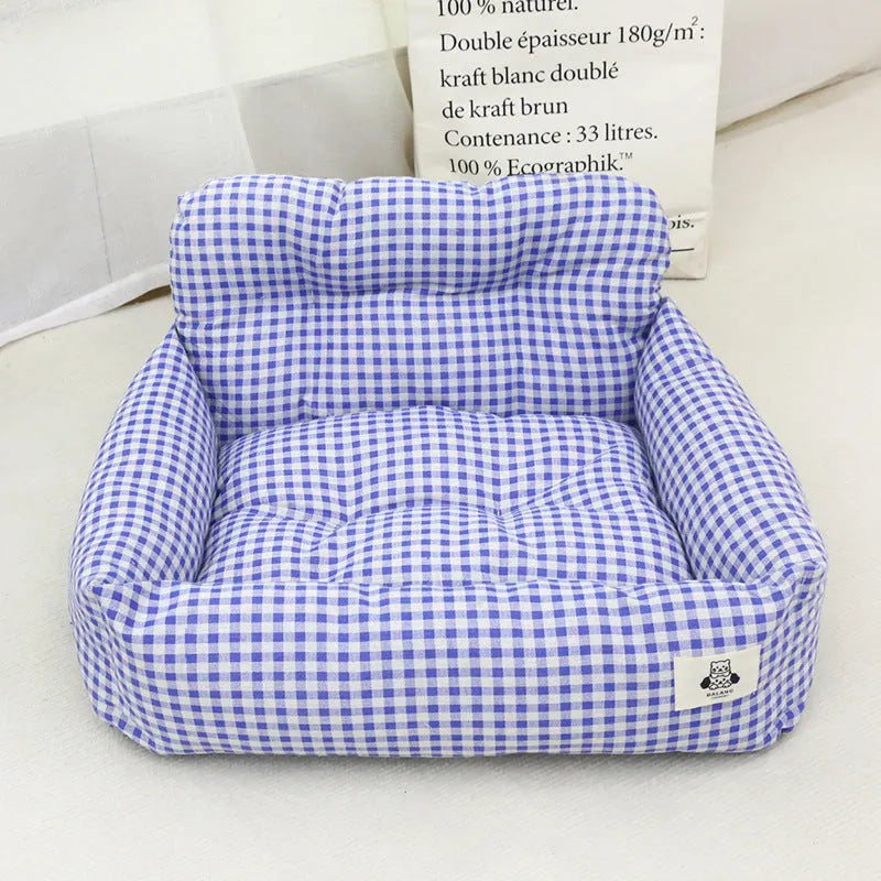 Grey and blue plaid cloth dog beds shown in two sizes for car travel.