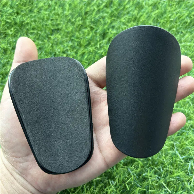 Extra small mini football shin guards in black and white plastic for youth players