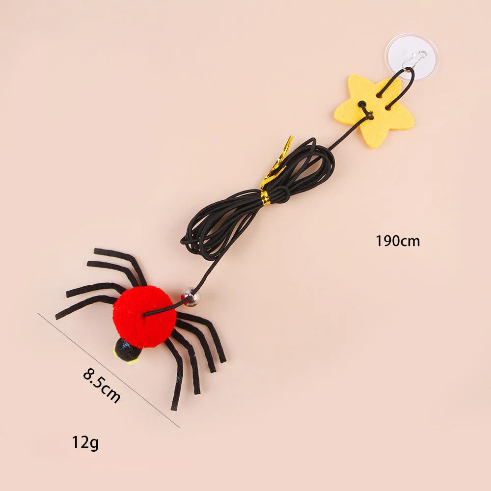 Red hanging cat toy with elastic rope, feathers, and bell spider ornament mounted on door