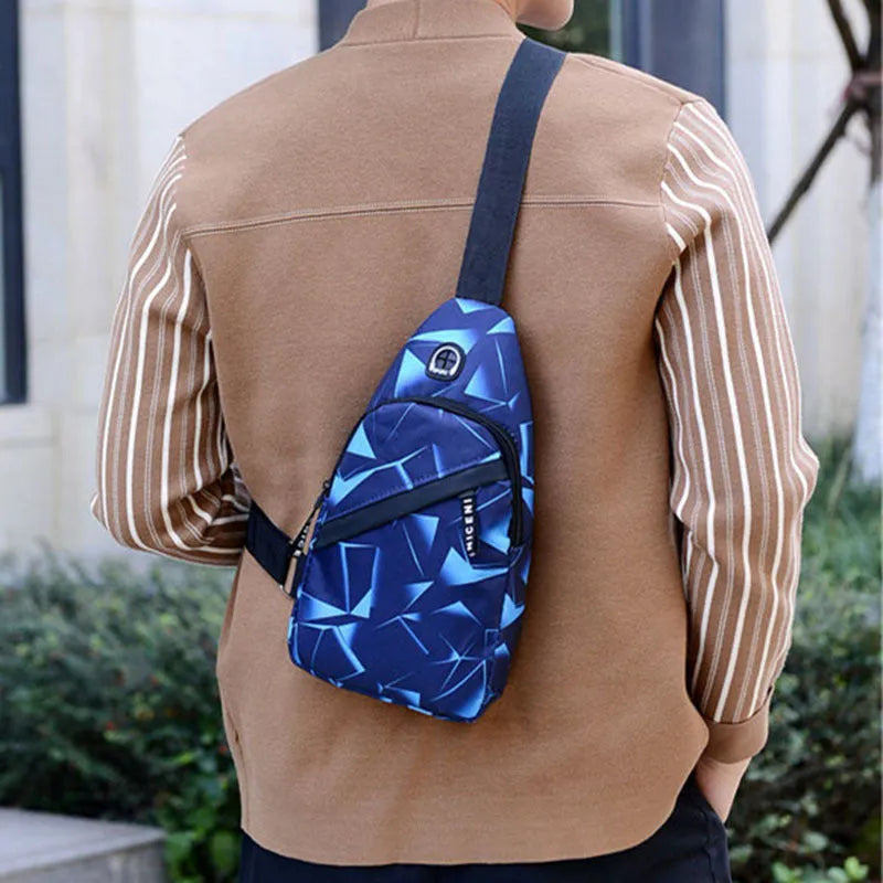 Blue men's crossbody sling bag with earphone hole, made from Oxford cloth, showing front zipper and strap.