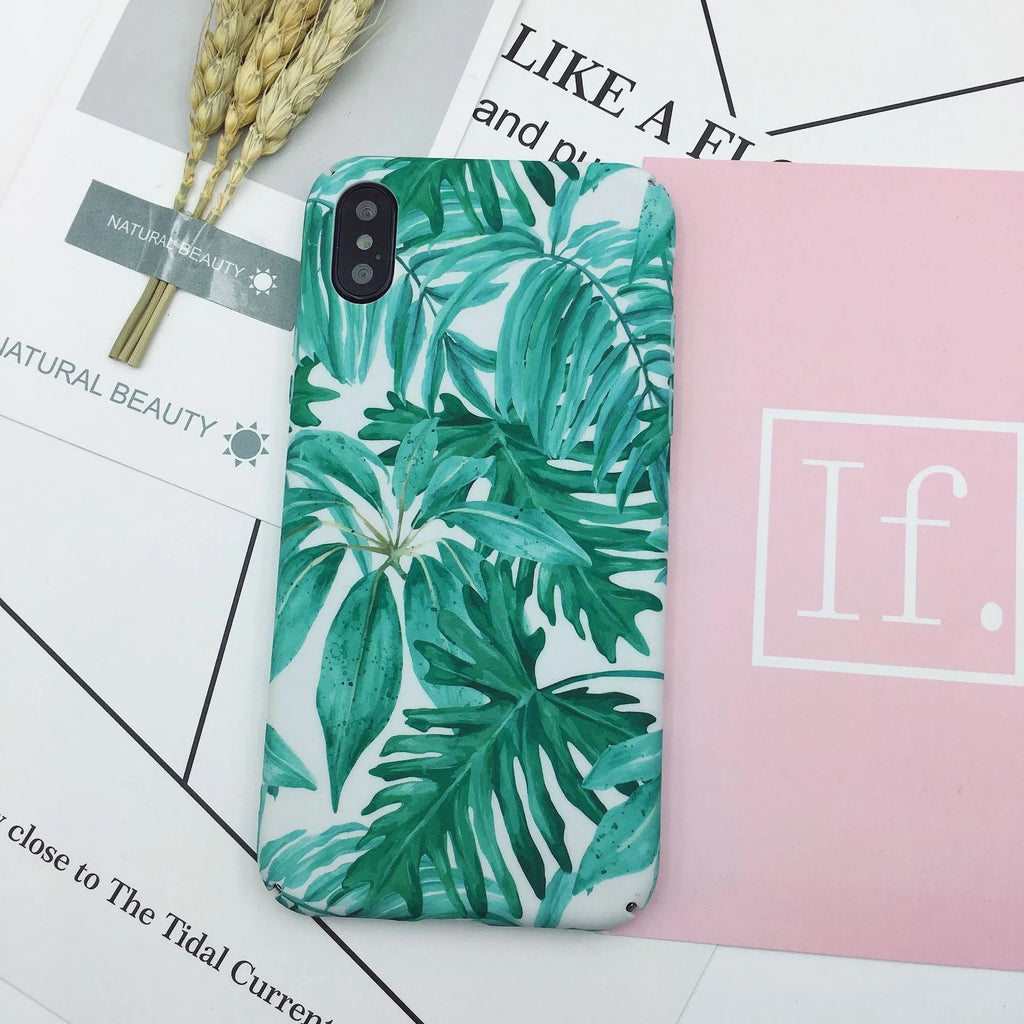Green and pink painted plastic back cover cases for mobile phones on a white background.