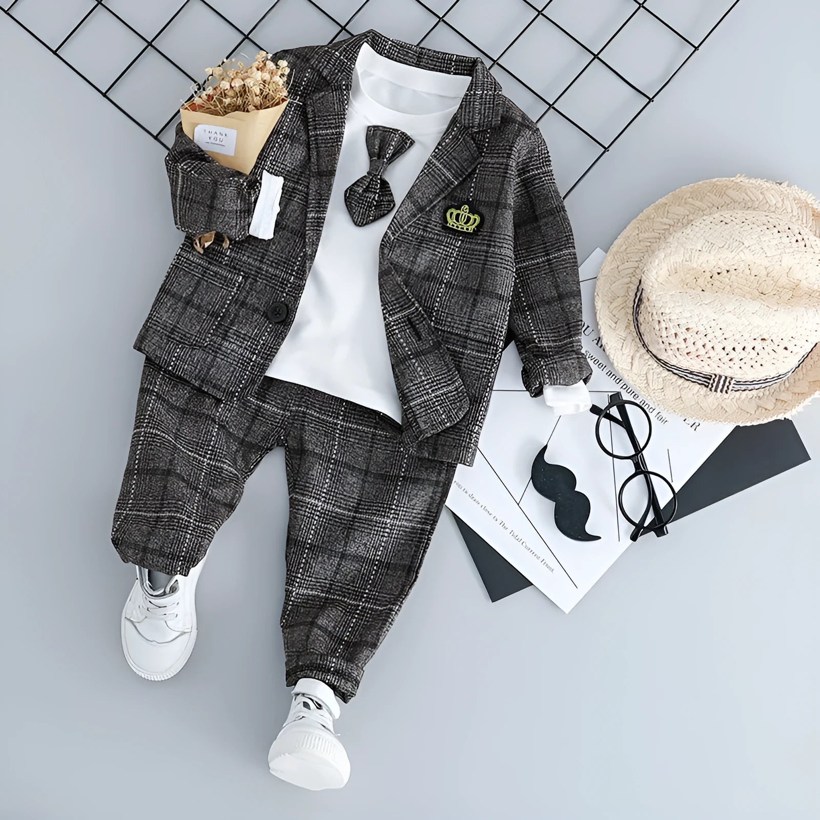 Infant boy's grey three-piece suit with long sleeves on a hanger.