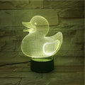 Little yellow duck 3D night light on a table, showing its cartoon design and colourful LED glow.