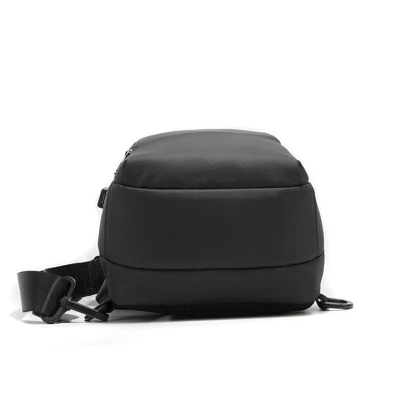Black anti-theft chest bag with lockable zipper and USB charging port, made from Polyamide fibre, worn as a crossbody bag