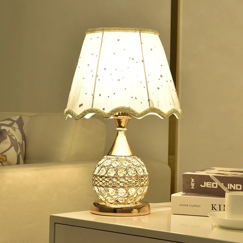 Gold crystal desk lamp with hand-finished pendant and iron art base on wooden surface