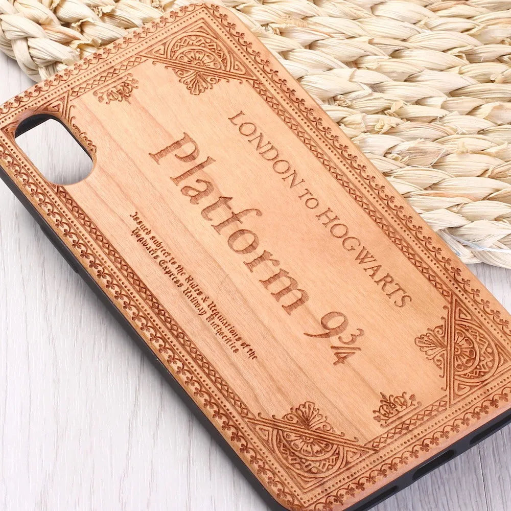 Wooden iPhone case with laser-engraved floral pattern and a black TPU bumper, shown on an iPhone.