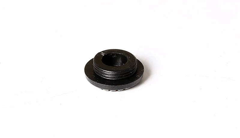 Black plastic camera shutter cover button 1cm diameter on white background