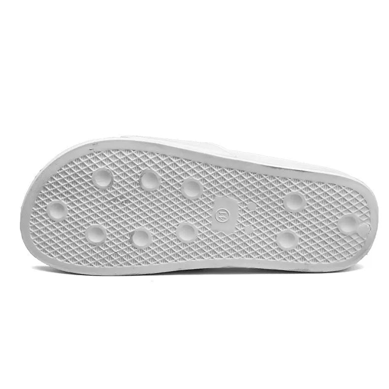 Men's black open-toe slipper with textured rubber sole, shown on a wooden floor.