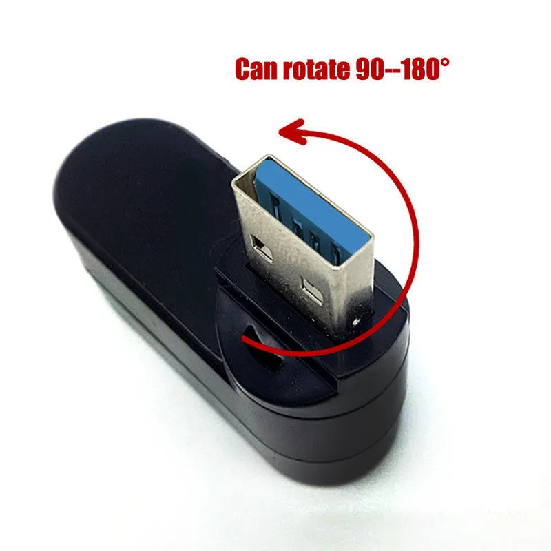 Black USB rotary splitter hub with four ports on a rotating white ABS body, shown on a desk.