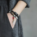 Men's black hair crystal bracelet with white crystal tassel in ethnic design with bending and lacing elements
