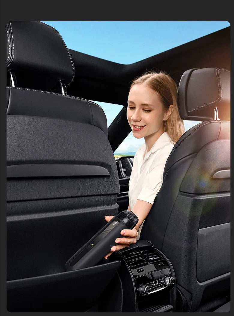 Starry sky black handheld car vacuum cleaner with a blowing hose attachment on a car seat.