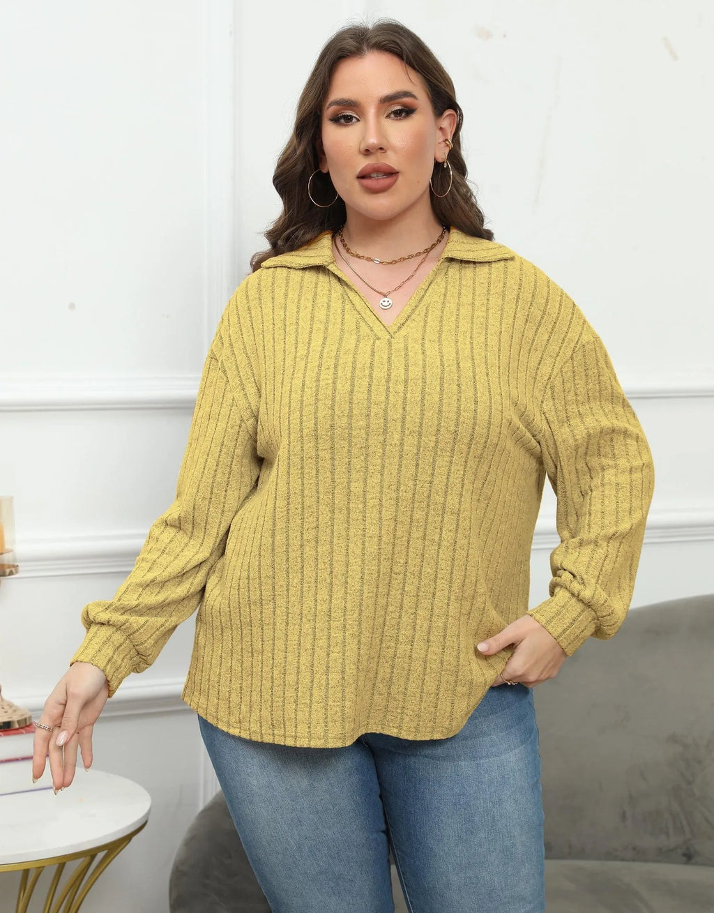 Women's plus size grey polo collar fleece shirt with lantern sleeves laid flat.