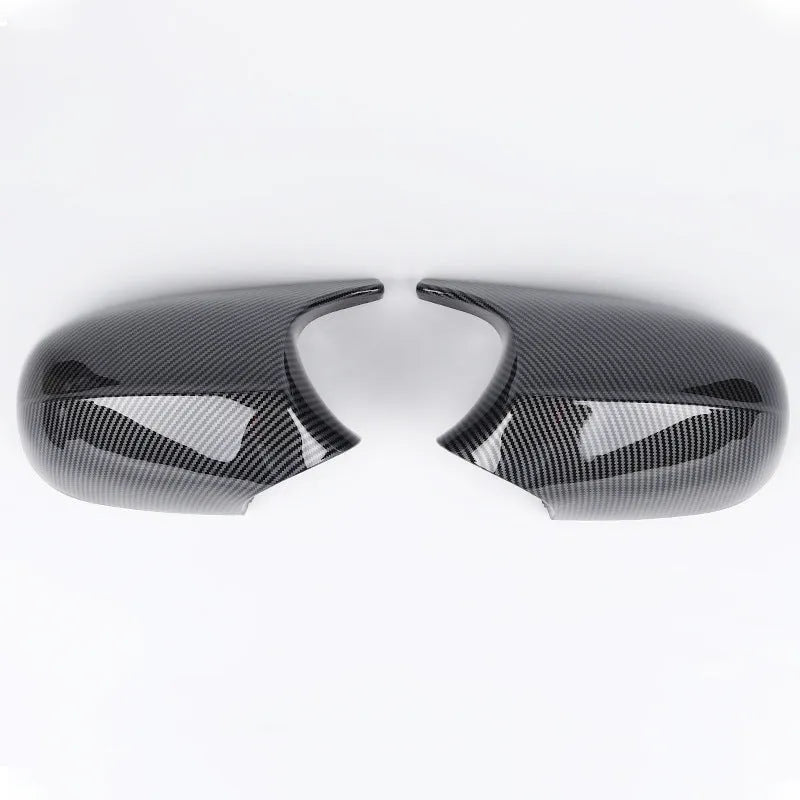 A pair of black ABS plastic rearview mirror shells for a BMW 3 Series E90 car.