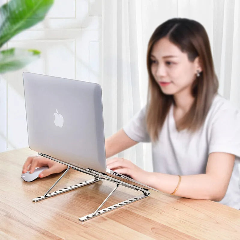Foldable aluminium laptop stand in silver with silicone pads and cable management slot for 7-15 inch laptops