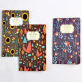 A5 kraft paper notebook with hand-stitched binding and a leather tassel, showing natural cover colour.