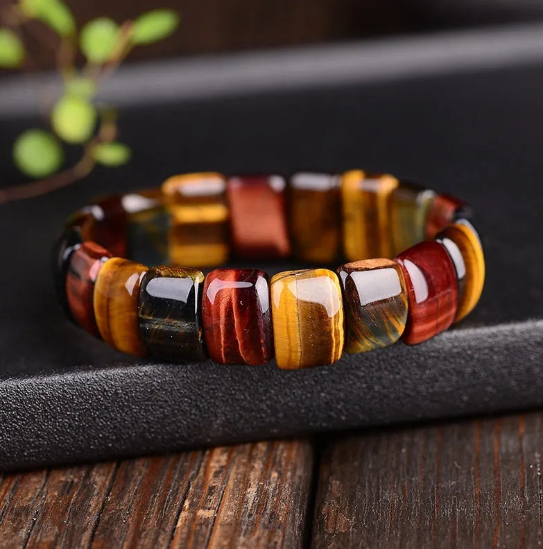 Natural tiger eye stone bracelet with round 14x10mm beads in red colour on a neutral background