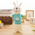 Soft plush rabbit-shaped pencil case in assorted colours, shown with pens inside.