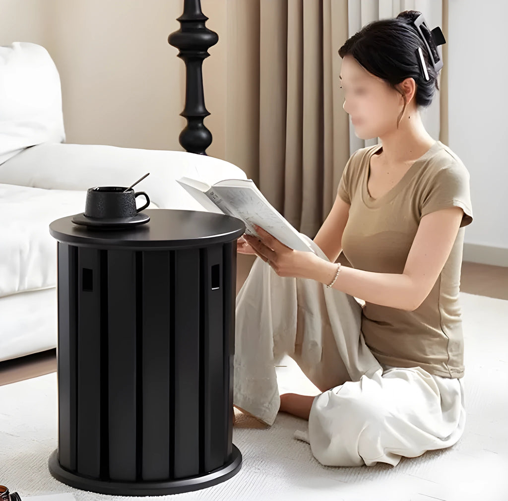 Two stackable round iron stools with splayed legs in a modern kitchen, showing smoked black and cream white colour options.