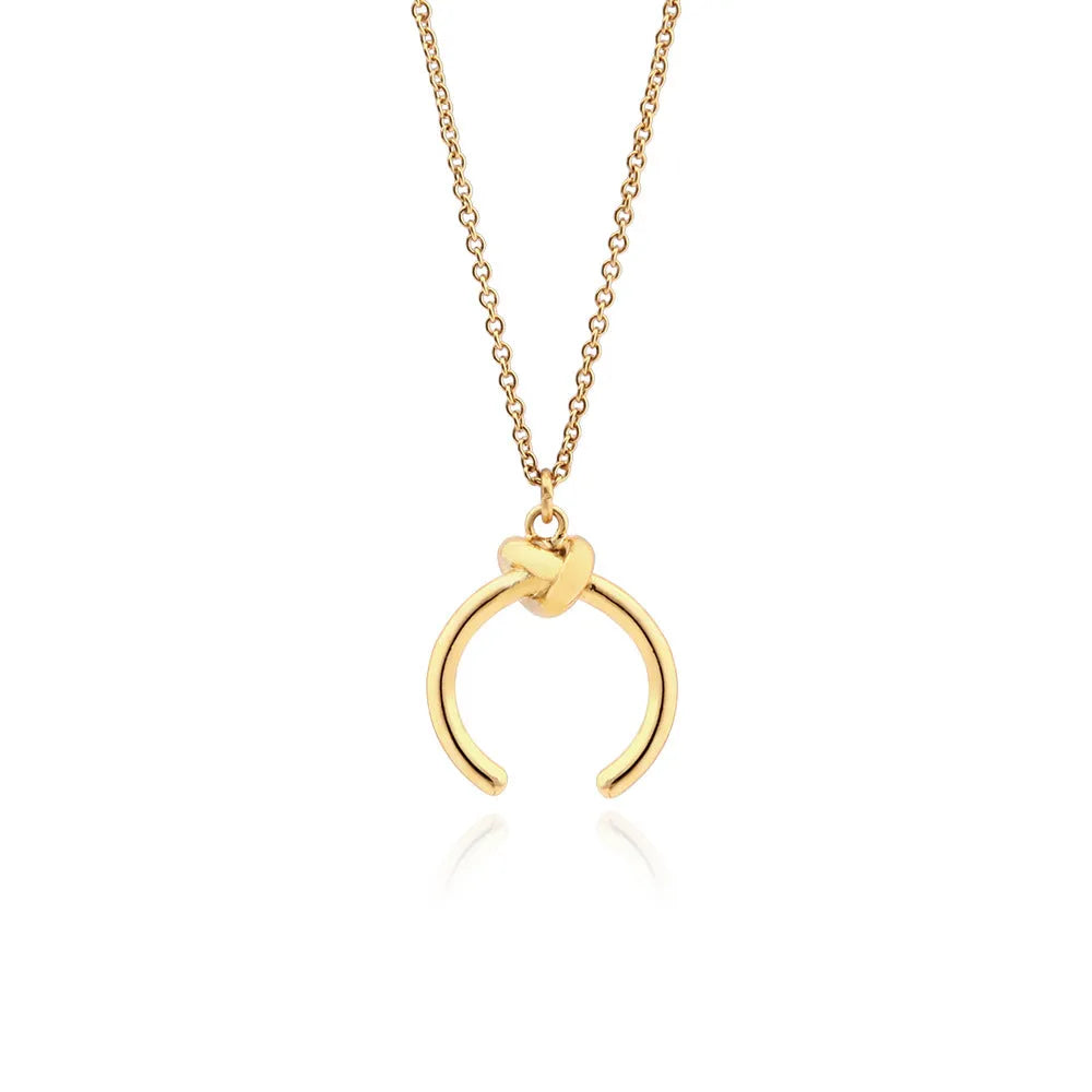 A vintage-style geometric pendant necklace with a cross chain, shown in gold and silver finishes.