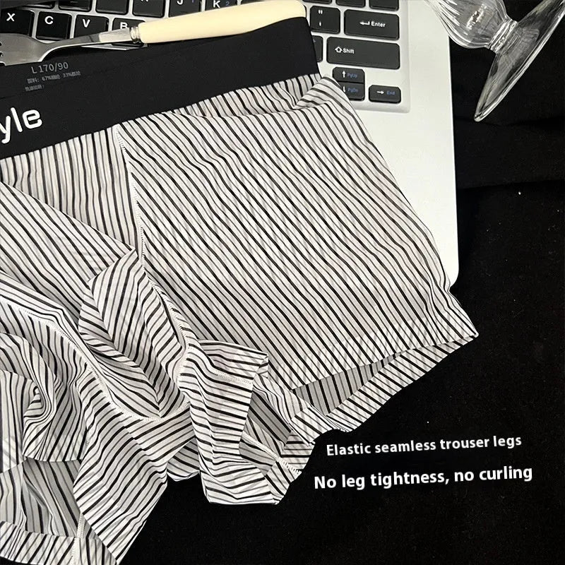 Men's ice silk boxer briefs in black showing seamless design and transparent crotch panel.
