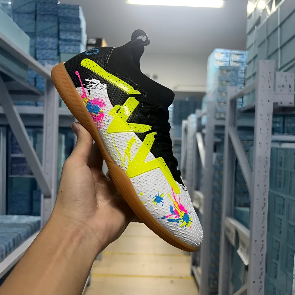 Low-top football boots in black and yellow with a PVC upper and non-slip rubber studded outsole.