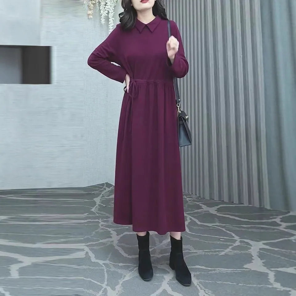 Purplish red women's long sleeve knee-length dress on a hanger, urban commute style.